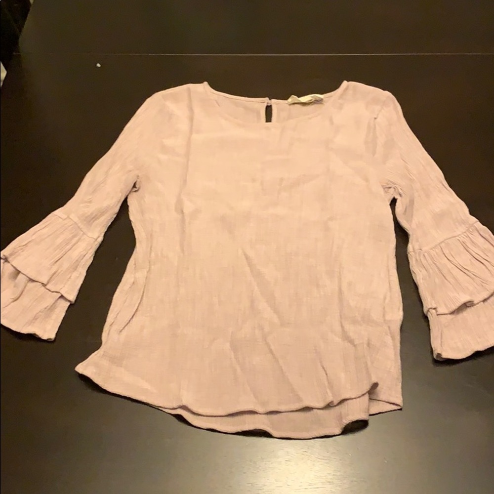 Size medium top but fits closer to a small